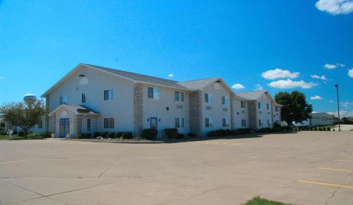 a large white building in a parking lot at Cobblestone Inn & Suites – Platteville in Platteville