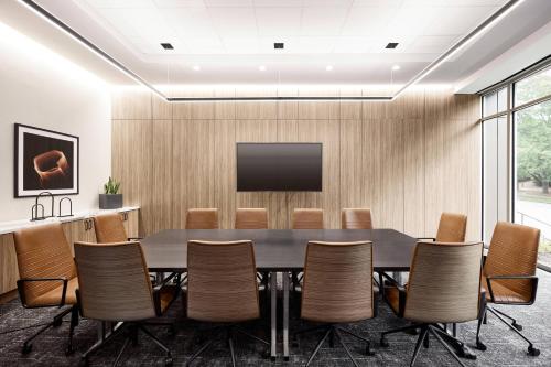 a conference room with a table and chairs at AC Hotel by Marriott Atlanta Perimeter in Atlanta
