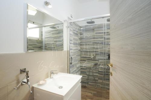 a bathroom with a sink and a shower with a mirror at Balconi sul mare in Otranto