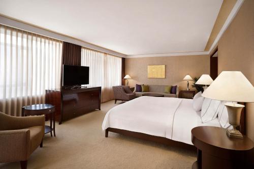 a hotel room with a large bed and a television at Westin Josun Seoul Hotel in Seoul