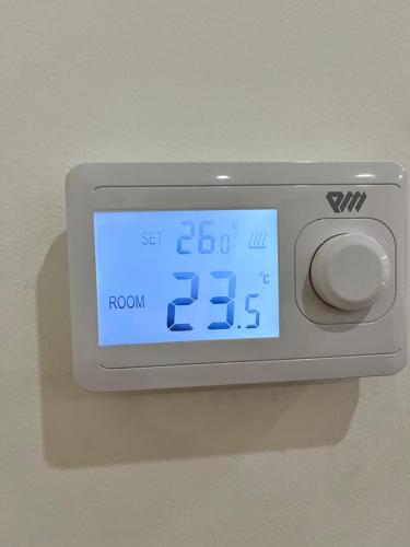 an alarm clock on a wall with a clock on it at Opsesija SPA in Kragujevac