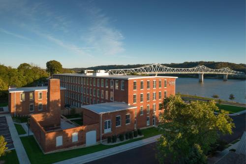 an overhead view of a building with a bridge in the background at Fairfield Inn & Suites Madison Historic Eagle Cotton Mill in Madison