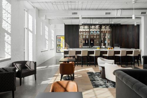 a bar in a room with chairs and a counter at Fairfield Inn & Suites Madison Historic Eagle Cotton Mill in Madison