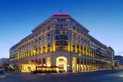 a large building on a city street at night at The Westin Grand Berlin in Berlin