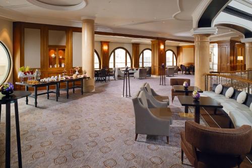 a lobby of a hotel with tables and chairs at The Westin Grand Berlin in Berlin