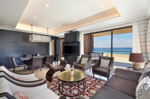 a living room filled with furniture and a television at Al Manara, a Luxury Collection Hotel, Aqaba in Aqaba