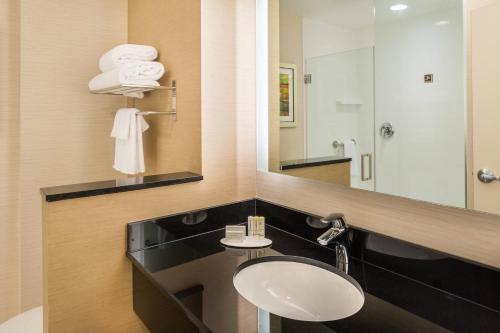 a bathroom with a sink and a mirror at Fairfield Inn & Suites by Marriott Orlando East/UCF Area in Orlando