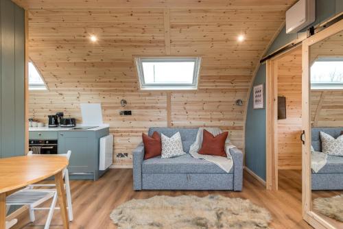 a living room with a couch and a table at Country Glamping in Bishop Auckland