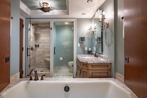 a bathroom with a large tub and a shower at Grand Bohemian Hotel Asheville, Autograph Collection in Asheville