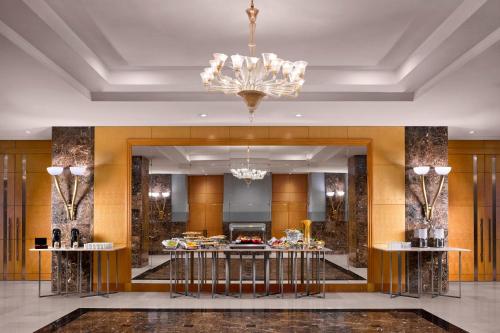a lobby of a hotel with a chandelier at Sheraton Amman Al Nabil Hotel in Amman