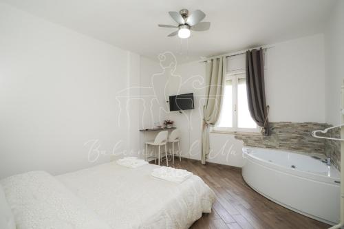 a bedroom with a bed and a tub and a television at Balconi sul mare in Otranto