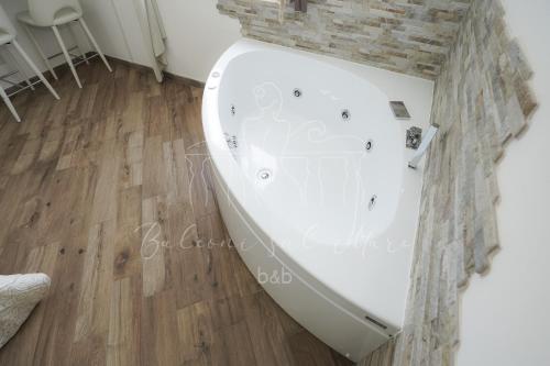a bath tub in a room with a wooden floor at Balconi sul mare in Otranto