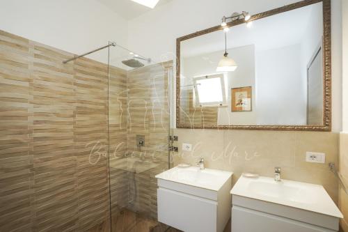 a bathroom with a shower and a sink and a mirror at Balconi sul mare in Otranto