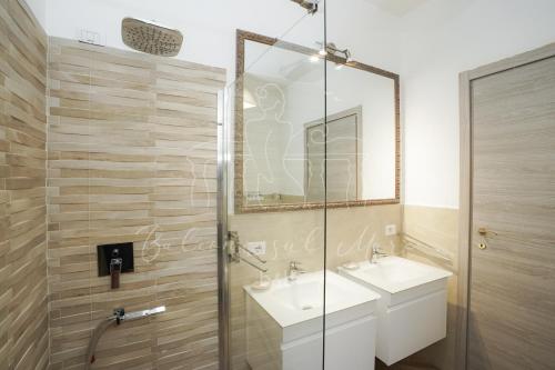 a bathroom with a sink and a glass shower at Balconi sul mare in Otranto