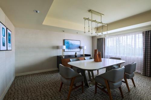 a dining room with a table and chairs at The Woodlands Waterway Marriott Hotel and Convention Center in The Woodlands