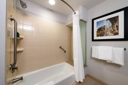 a bathroom with a shower and a bath tub at Courtyard High Point in High Point