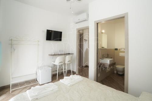 a bedroom with a bed and a bathroom with a sink at Balconi sul mare in Otranto