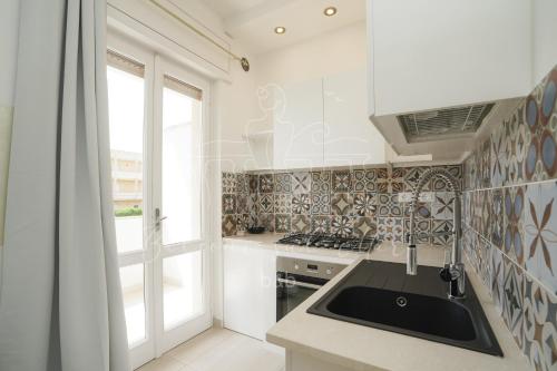 a kitchen with a sink and a stove at Balconi sul mare in Otranto