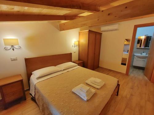 a bedroom with a bed with two towels on it at Borgo Sciugolo in Baselice