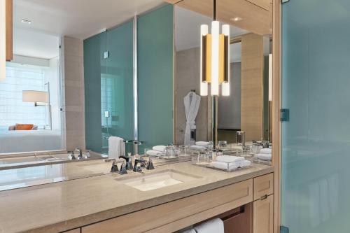 a bathroom with a sink and a large mirror at The St. Regis San Francisco in San Francisco
