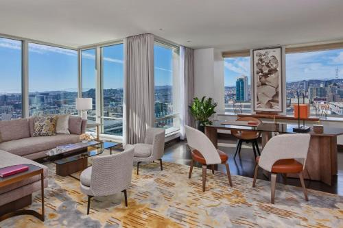 a living room with a couch and a table and chairs at The St. Regis San Francisco in San Francisco