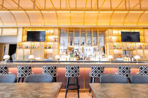 a bar in a restaurant with tables and chairs at The St. Regis San Francisco in San Francisco