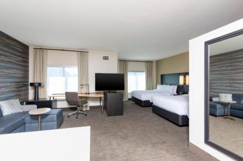 a hotel room with two beds and a desk at Residence Inn by Marriott Indianapolis South/Greenwood in Indianapolis