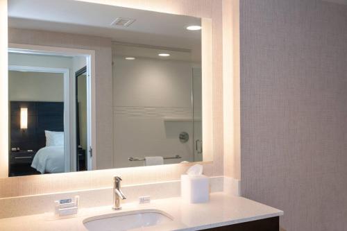 a bathroom with a sink and a large mirror at Residence Inn by Marriott Indianapolis South/Greenwood in Indianapolis