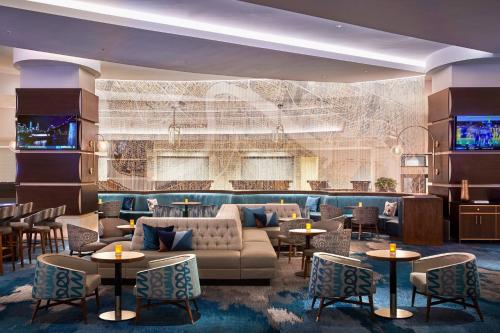 a lobby with a couch and tables and chairs at New Orleans Marriott in New Orleans