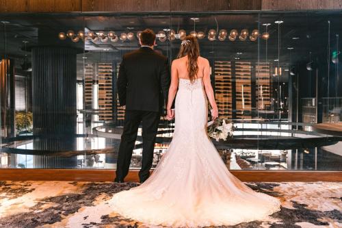 a bride and groom standing in a room at AC Hotel by Marriott Austin-University in Austin