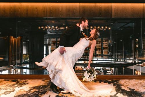 a bride and groom dancing on a dance floor at AC Hotel by Marriott Austin-University in Austin