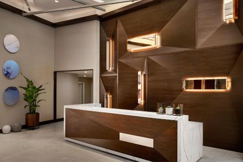 a large bathroom with a large wooden wall at AC Hotel by Marriott Austin-University in Austin