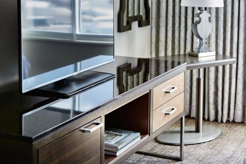 a dresser with a tv on top of it at New Orleans Marriott in New Orleans