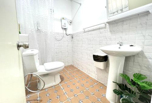 a bathroom with a toilet and a sink at Seamsak hotel in Golden Triangle