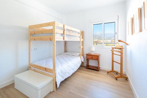 a bedroom with a bunk bed and a window at Piso Estrella 031 in Torre del Mar