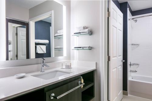 a bathroom with a sink and a mirror at Residence Inn by Marriott Tulsa South in Tulsa