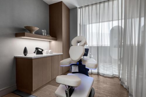 una sala de cita con el dentista con una silla blanca en W Dallas - Victory, en Dallas