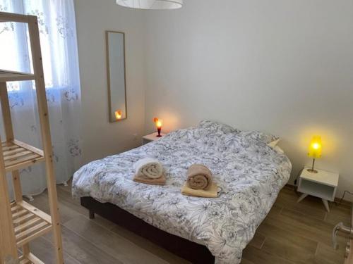 une chambre avec un lit avec des serviettes dessus dans l'établissement Marycel t2 avec terrasse wifi clim et garage, à Bandol