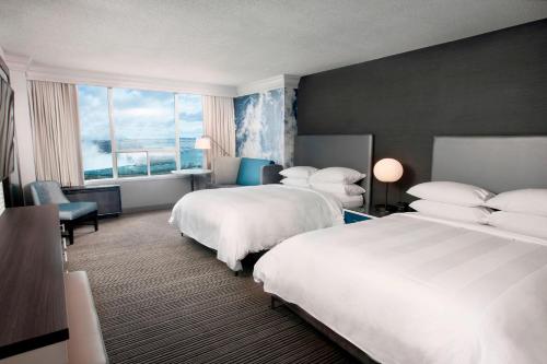 a hotel room with two beds and a window at Niagara Falls Marriott on the Falls in Niagara Falls