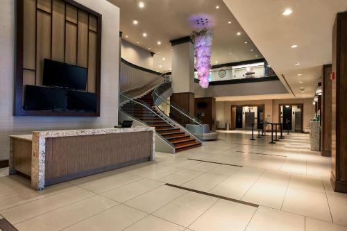 a lobby with a spiral staircase and a large lobby with a building at Niagara Falls Marriott on the Falls in Niagara Falls