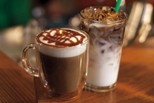 two cups of coffee sitting on a wooden table at Niagara Falls Marriott on the Falls in Niagara Falls