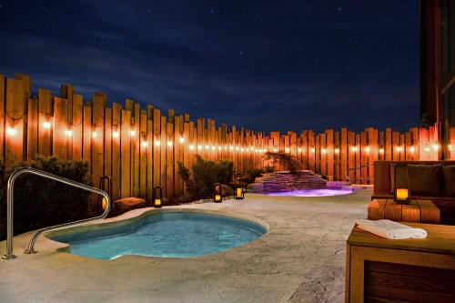 a hot tub in a patio with a wooden fence at Niagara Falls Marriott on the Falls in Niagara Falls