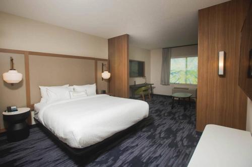 a hotel room with a white bed and a desk at Fairfield Inn & Suites by Marriott Philadelphia Broomall/Newtown Square in Broomall