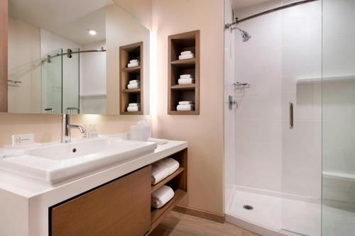 a bathroom with a sink and a shower at Courtyard by Marriott Phoenix Downtown in Phoenix