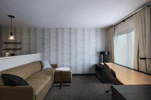 a living room with a couch and a flat screen tv at Residence Inn New Brunswick Tower Center Blvd. in East Brunswick