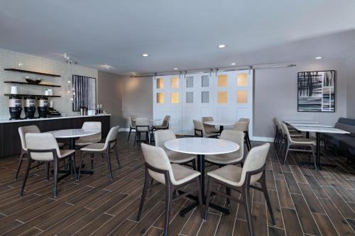 a restaurant with tables and chairs and a bar at Residence Inn New Brunswick Tower Center Blvd. in East Brunswick