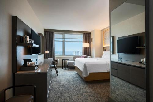 um quarto de hotel com uma cama e uma grande janela em The Westin Chicago Lombard em Lombard
