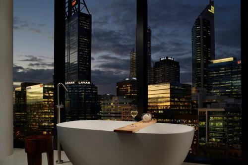 a bath tub with a view of a city skyline at The Ritz-Carlton, Perth in Perth