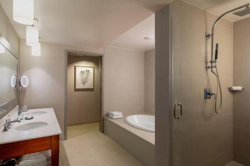 a bathroom with a shower and a sink and a tub at The Westin Chicago Lombard in Lombard
