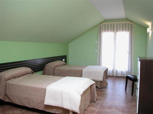 En eller flere senge i et værelse på Capricho de Bascuas